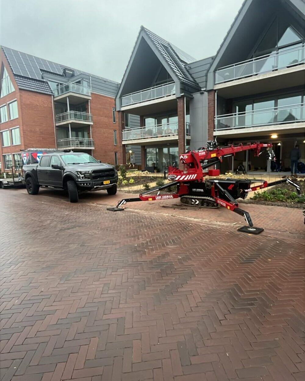 Mini hijskraan bij een appartementengebouw